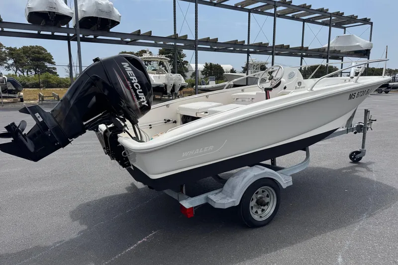 Slide: The Image of 2018 Boston Whaler 130 Super Sport boat on trailer with Mercury outboard engine. - 4
