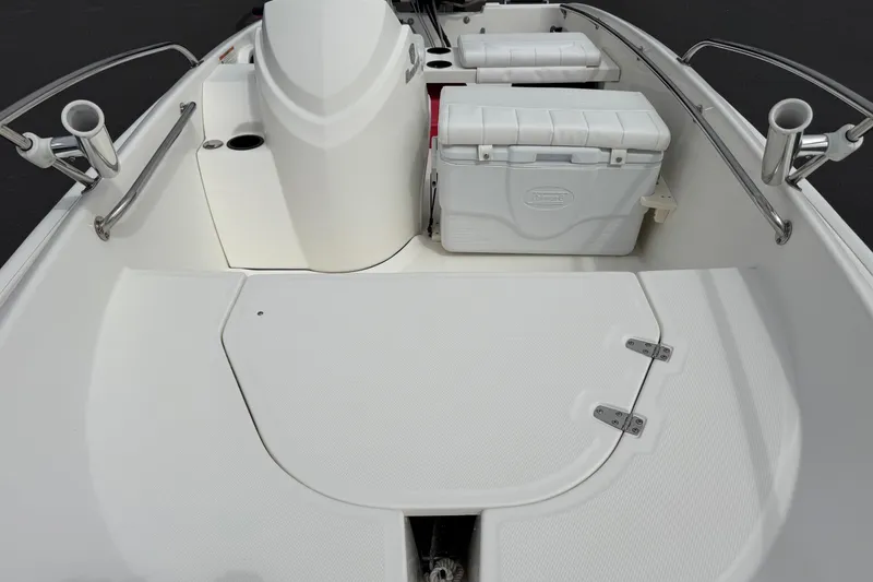 Slide: The Image of 2018 Boston Whaler 130 Super Sport boat interior with storage and seating. - 5