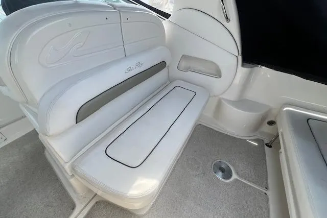Slide: The Image of 2006 Sea Ray 300 Sundancer interior seating with white upholstery and elegant design. - 10