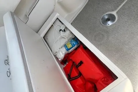 Slide: The Image of Storage compartment on 2006 Sea Ray 300 Sundancer boat with life jackets and supplies. - 12
