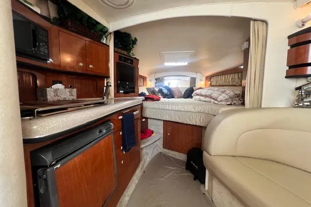 Slide: The Image of Interior of 2006 Sea Ray 300 Sundancer with kitchenette and cozy sleeping area. - 14