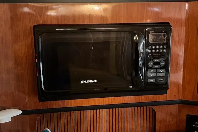 Slide: The Image of Sylvania microwave in 2006 Sea Ray 300 Sundancer yacht kitchen. - 19