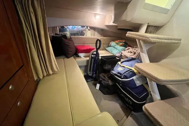 Slide: The Image of Interior cabin of a 2006 Sea Ray 300 Sundancer with seating and storage. - 22