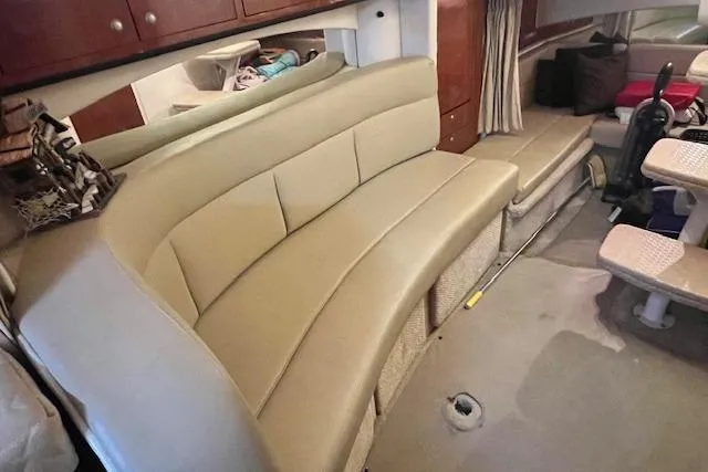 Slide: The Image of Interior of 2006 Sea Ray 300 Sundancer with beige seating and storage cabinets. - 24