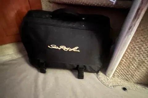 Slide: The Image of Black Sea Ray bag on a 2006 Sea Ray 300 Sundancer boat interior. - 26