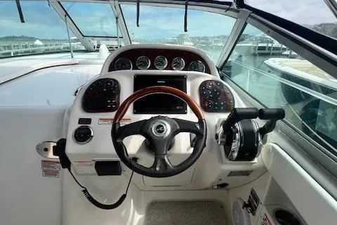 Slide: The Image of Cockpit view of 2006 Sea Ray 300 Sundancer with steering wheel and control panel. - 3