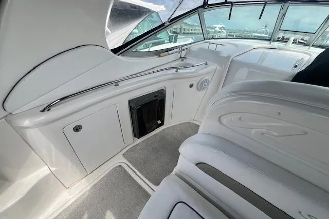 Slide: The Image of 2006 Sea Ray 300 Sundancer interior with white seating and sleek design. - 7