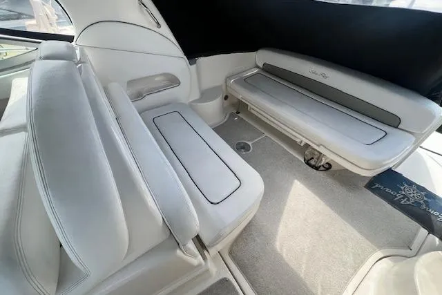 Slide: The Image of 2006 Sea Ray 300 Sundancer interior with white seating and carpeted floor. - 8