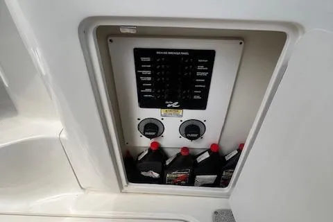 Slide: The Image of Control panel and storage area on a 2006 Sea Ray 300 Sundancer boat. - 9