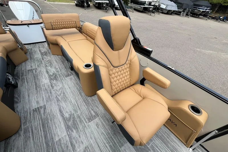 Slide: The Image of Luxurious seating on 2025 Avalon Catalina Quad Lounger Shift Windshield boat, featuring tan upholstery and cup holders. - 14