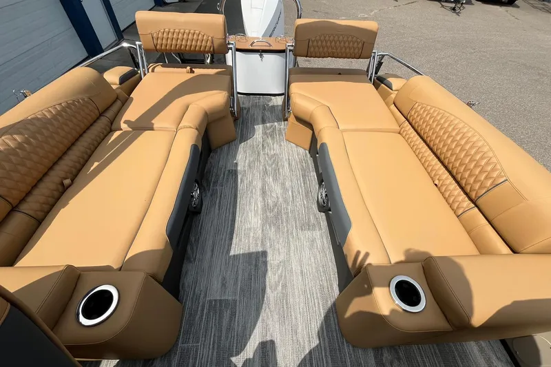 Slide: The Image of Luxurious seating on 2025 Avalon Catalina Quad Lounger Shift Windshield boat, featuring tan upholstery. - 18