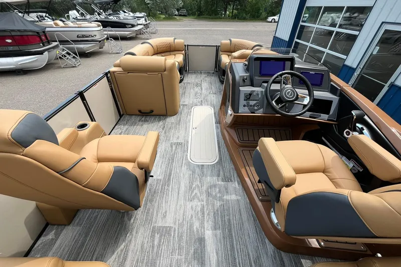 Slide: The Image of 2025 Avalon Catalina Quad Lounger boat interior with tan seating and modern dashboard. - 22
