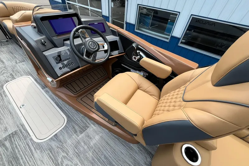 Slide: The Image of 2025 Avalon Catalina Quad Lounger Shift Windshield boat interior with luxurious seating and modern dashboard. - 23