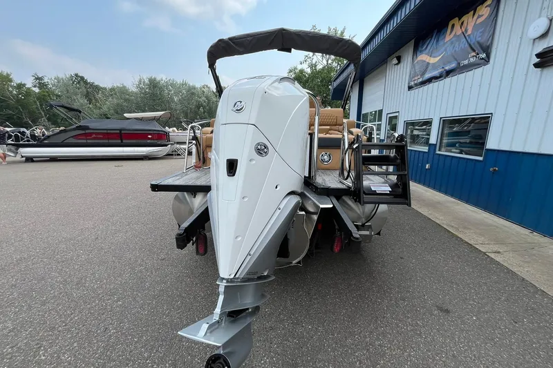 Slide: The Image of 2025 Avalon Catalina Quad Lounger Shift Windshield boat at marina, rear view. - 3
