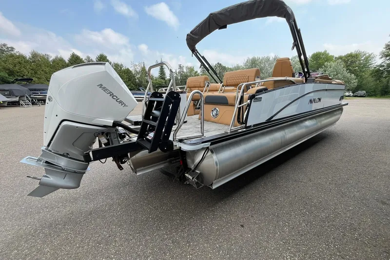 Slide: The Image of 2025 Avalon Catalina Quad Lounger pontoon boat with Mercury engine, parked outdoors. - 4