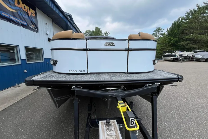 Slide: The Image of 2025 Avalon Catalina Quad Lounger Shift Windshield boat on trailer at marina. - 6
