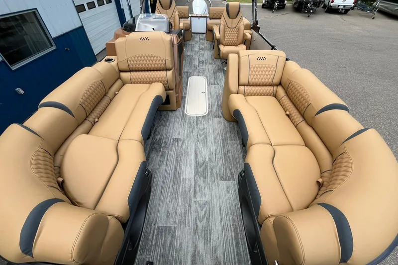 Slide: The Image of Luxurious interior of 2025 Avalon Catalina Quad Lounger pontoon boat with tan seating. - 9