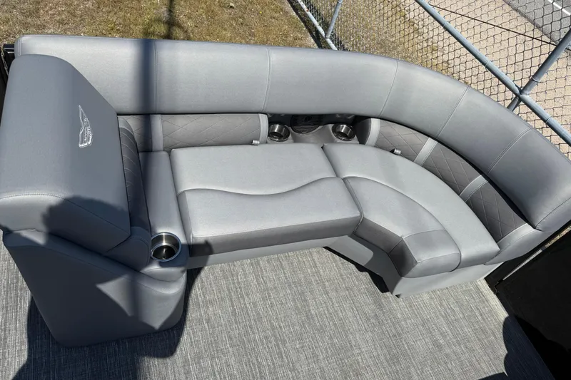 Slide: The Image of 2024 Bennington 23LSB boat interior with luxurious gray seating and cup holders. - 2