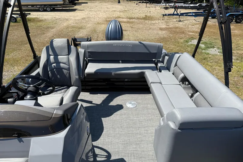 Slide: The Image of 2024 Bennington 23LSB pontoon boat interior with gray seating and steering wheel. - 4