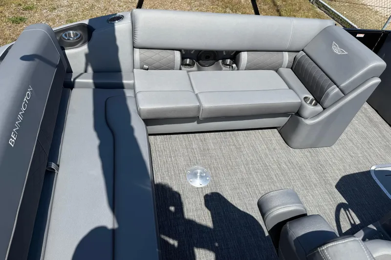 Slide: The Image of 2024 Bennington 23LSB boat interior with gray seating and cup holders. - 5