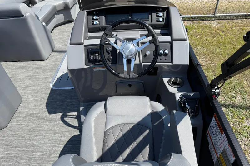 Slide: The Image of 2024 Bennington 23LSB boat helm with modern steering wheel and control panel. - 6