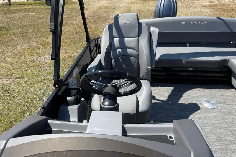 Slide: The Image of 2024 Bennington 23LSB boat interior with steering wheel and seating. - 8