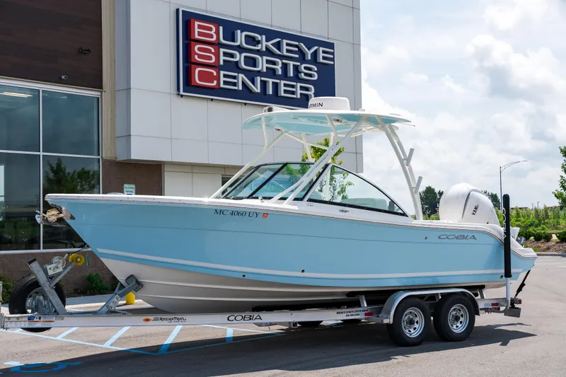 The Image of 2023 Cobia 240 Dual Console boat at Buckeye Sports Center, displayed on a trailer. - 0