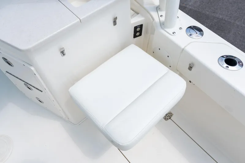 Slide: The Image of 2023 Cobia 240 Dual Console boat storage compartment with rope and fender. - 10