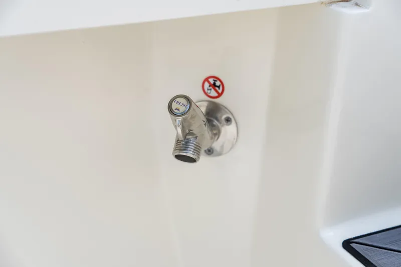 Slide: The Image of 2023 Cobia 240 Dual Console boat interior with cushioned seating and storage compartments. - 12