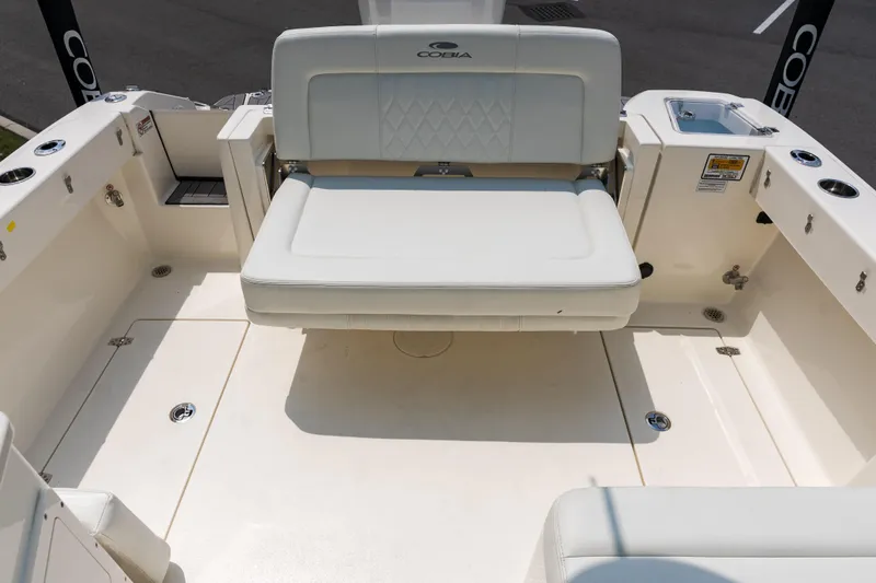 Slide: The Image of Boat drain and raw water outlet on 2023 Cobia 240 Dual Console. - 13