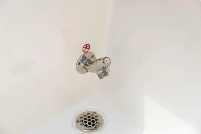 Slide: The Image of 2023 Cobia 240 Dual Console boat storage compartment with cushioned seating. - 14