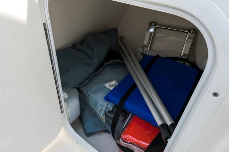 Slide: The Image of 2023 Cobia 240 Dual Console boat storage compartment with cushions. - 21