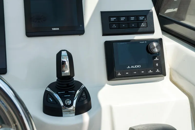 Slide: The Image of Control panel of 2023 Cobia 240 Dual Console boat with labeled switches. - 26