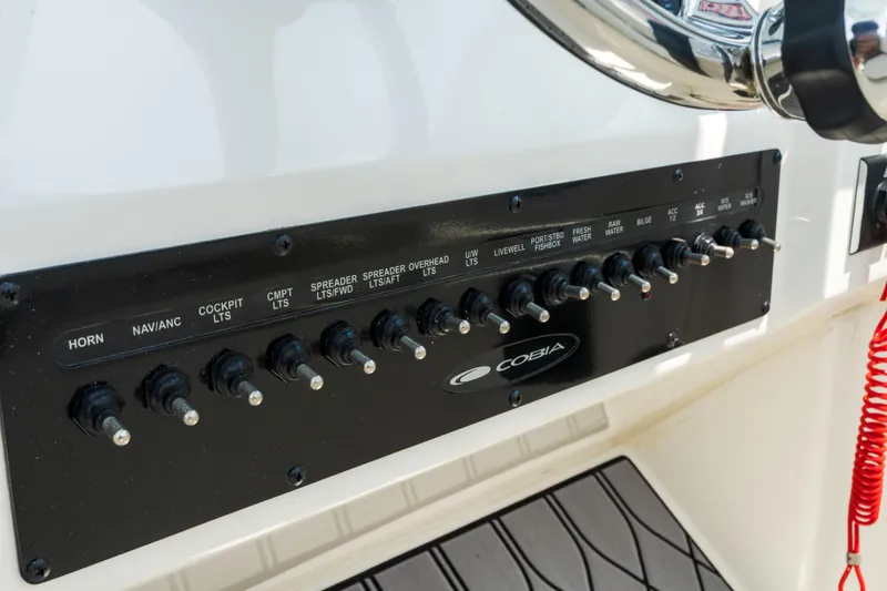 Slide: The Image of 2023 Cobia 240 Dual Console boat interior with spacious seating and storage compartments. - 27