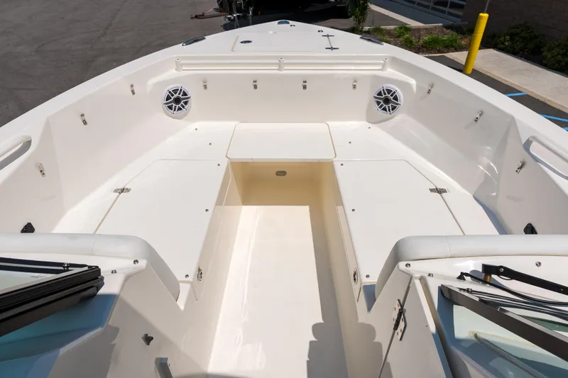 Slide: The Image of 2023 Cobia 240 Dual Console boat seat with open storage compartment. - 28