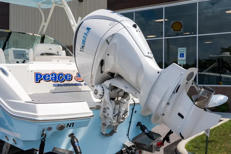 Slide: The Image of 2023 Cobia 240 Dual Console boat with ladder on trailer. - 4