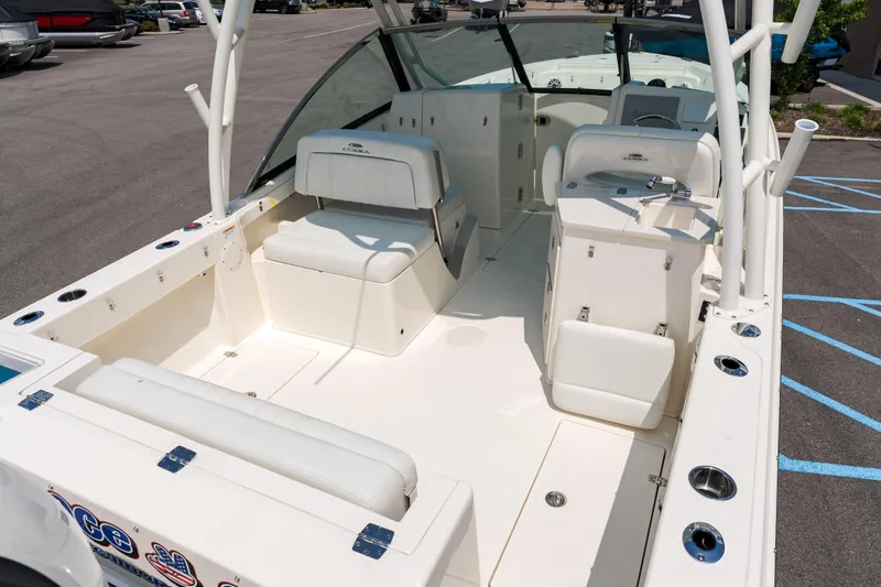 Slide: The Image of 2023 Cobia 240 Dual Console boat interior with seating and storage compartments. - 6