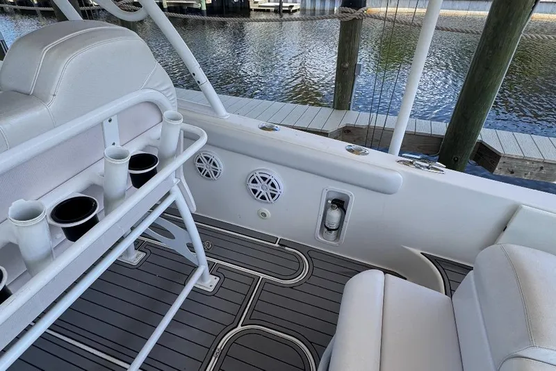 Slide: The Image of Interior of a 2012 Concept 32 boat with rod holders and seating by the dock. - 10