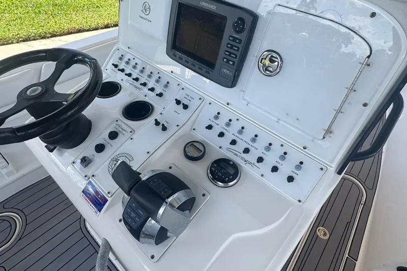Slide: The Image of Boat control panel with steering wheel, throttle, and navigation system, Concept 32, 2012 model. - 13