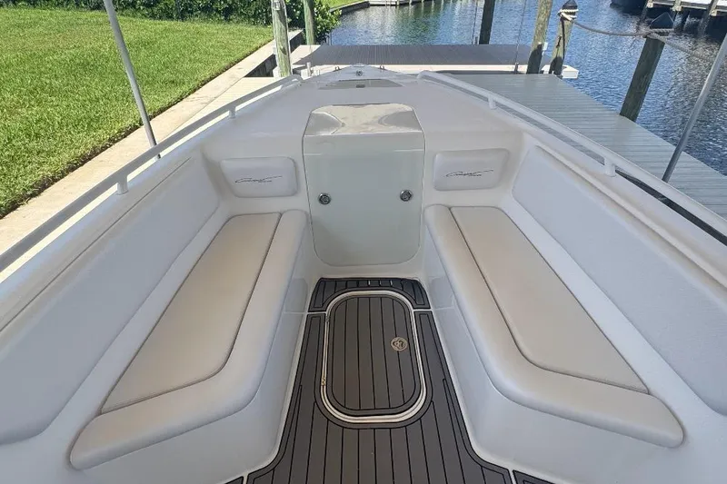 Slide: The Image of Interior of a 2012 Concept 32 boat with white seating and teak flooring. - 18