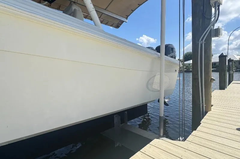Slide: The Image of 2012 Concept 32 boat docked by a wooden pier under a clear blue sky. - 19