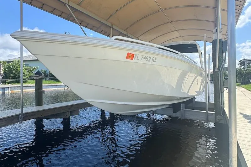 Slide: The Image of 2012 Concept 32 boat docked under a canopy on a sunny day. - 2