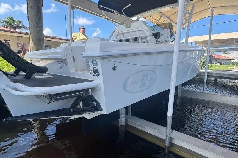 Slide: The Image of 2012 Concept 32 boat docked under canopy with person onboard. - 3