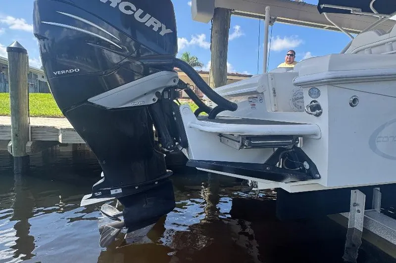 Slide: The Image of 2012 Concept 32 boat with Mercury Verado outboard motor, docked in sunny marina. - 5