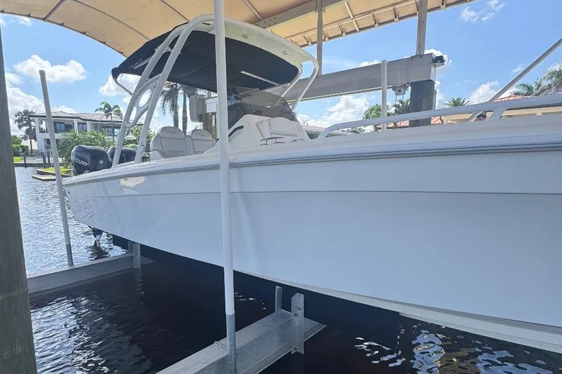 Slide: The Image of 2012 Concept 32 boat on lift, under canopy, near waterfront homes. - 6