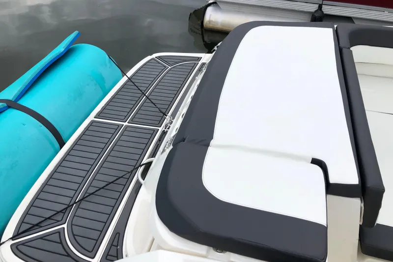 Slide: The Image of 2021 Bayliner VR5 Bowrider I/O with swim platform and blue float on water. - 5