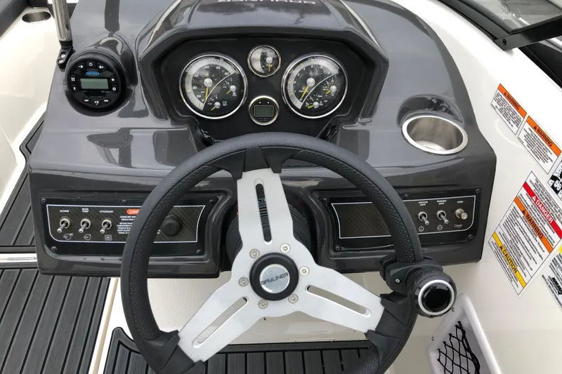 Slide: The Image of 2021 Bayliner VR5 Bowrider I/O dashboard with steering wheel and control panel. - 9