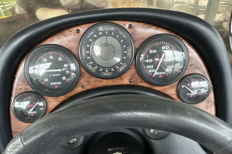 Slide: The Image of Dashboard of a 1999 Tracker Bass Tracker 896 DC boat with gauges and steering wheel. - 4