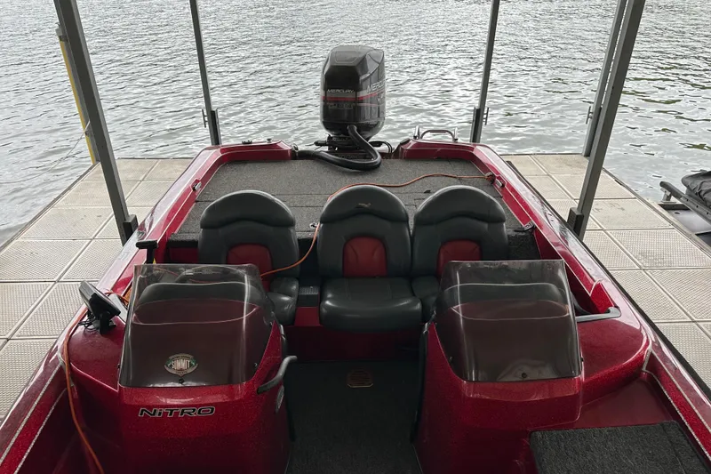 Slide: The Image of 1999 Tracker Bass Tracker 896 DC boat with dual consoles, docked by the water. - 8