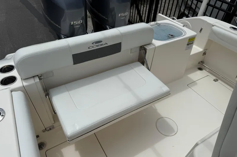 Slide: The Image of 2022 Cobia 240 Center Console boat interior with seating and dual Yamaha 150 engines. - 15